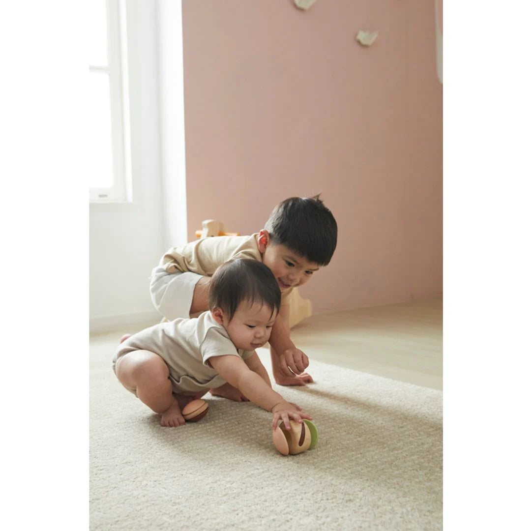 Two children playing with Clapping Roller