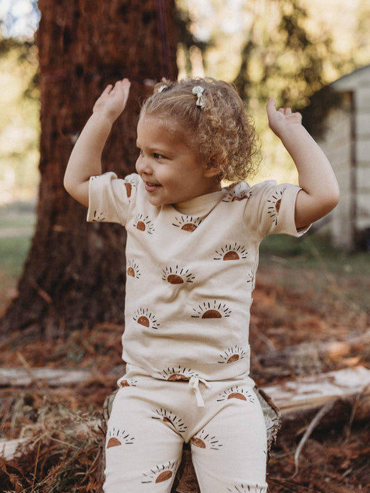 child playing outside wearing sun organic short sleeve tee