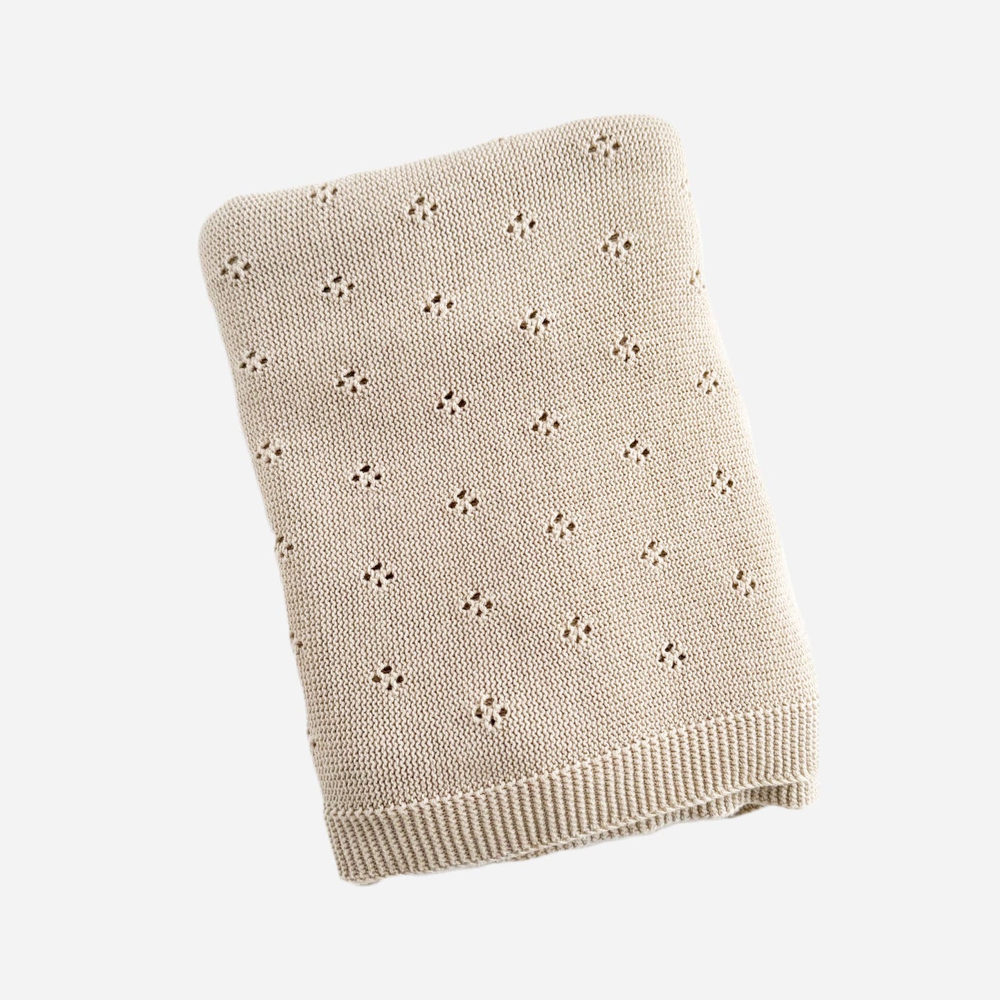 Beige embroidered knitted blanket with a subtle pattern on a white background