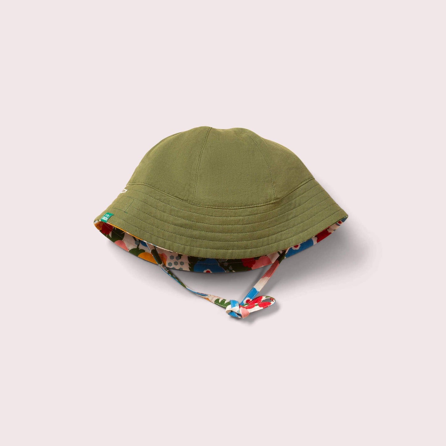 Green sun hat with floral interior lining on a light gray background