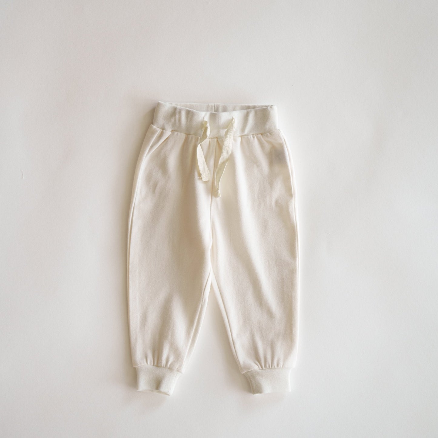 White sweatpants on a light gray background