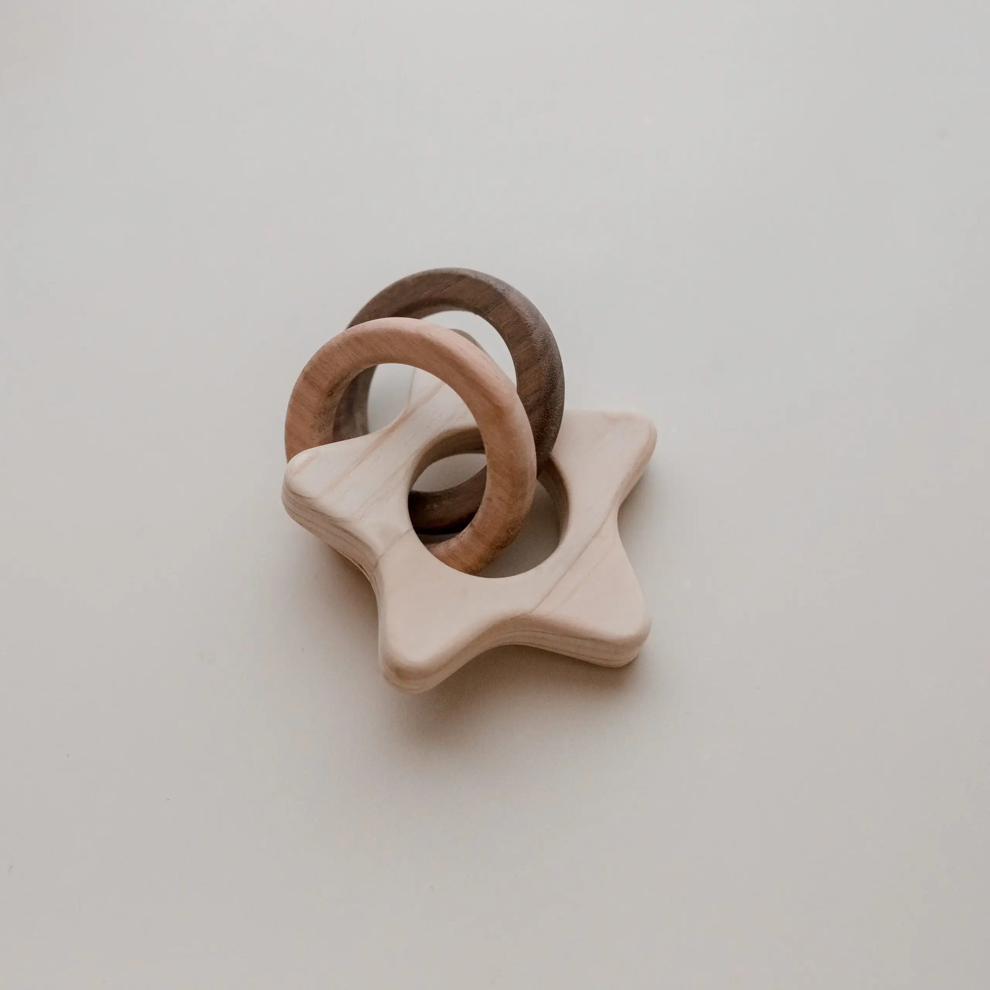 wooden star rattle with two wooden rings