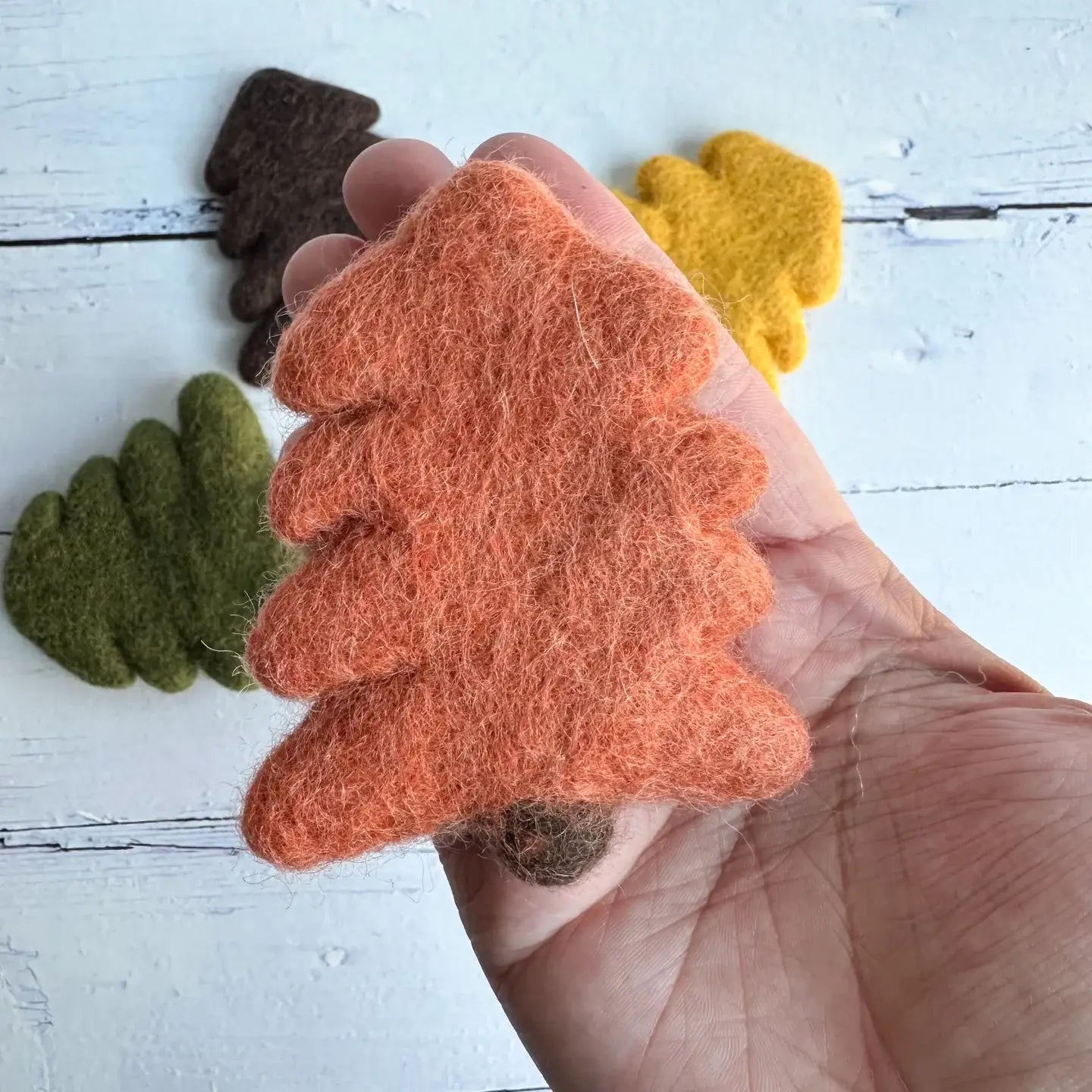 hand holding a felt orange tree
