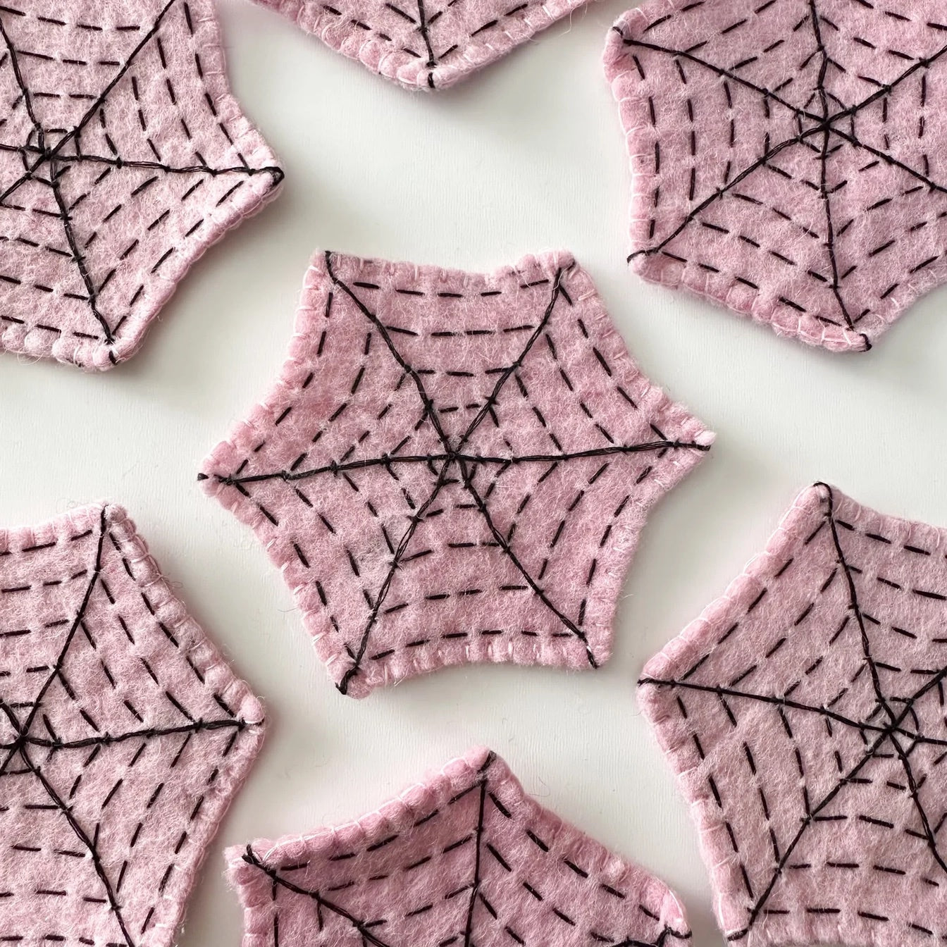 Pink felt spider webs