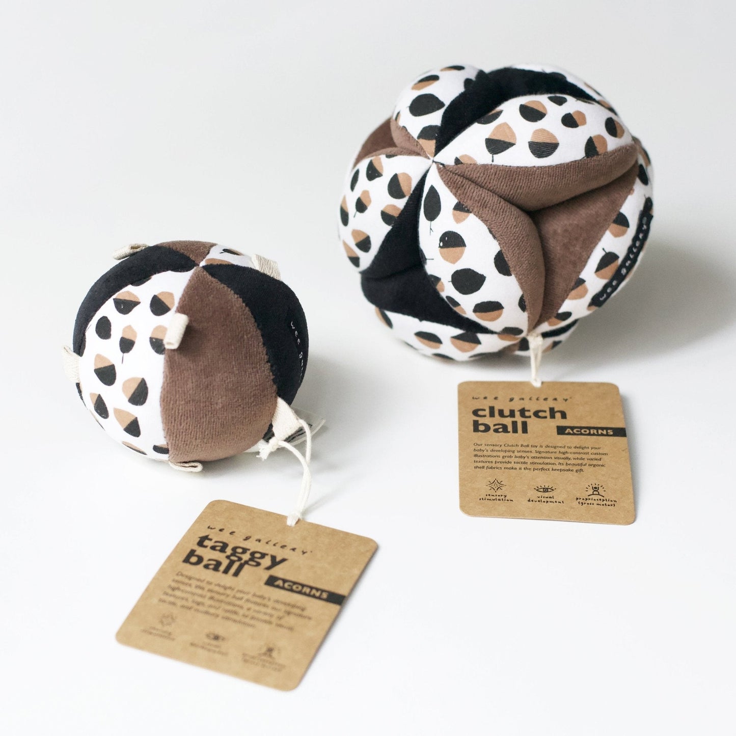 Two taggy balls with a leopard print pattern on a white background, accompanied by tags.