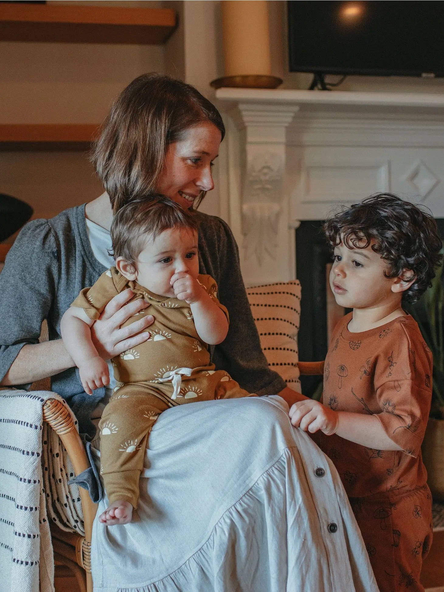 Parent sitting down with children wearing Ziwi baby organic sets