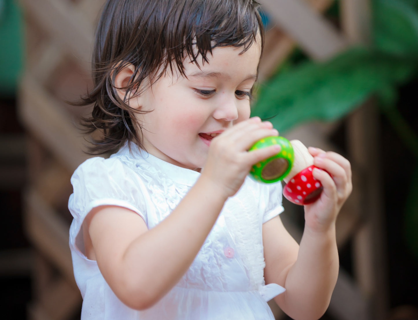 child looking through Mushroom Kaleidoscopes by Plan Toys