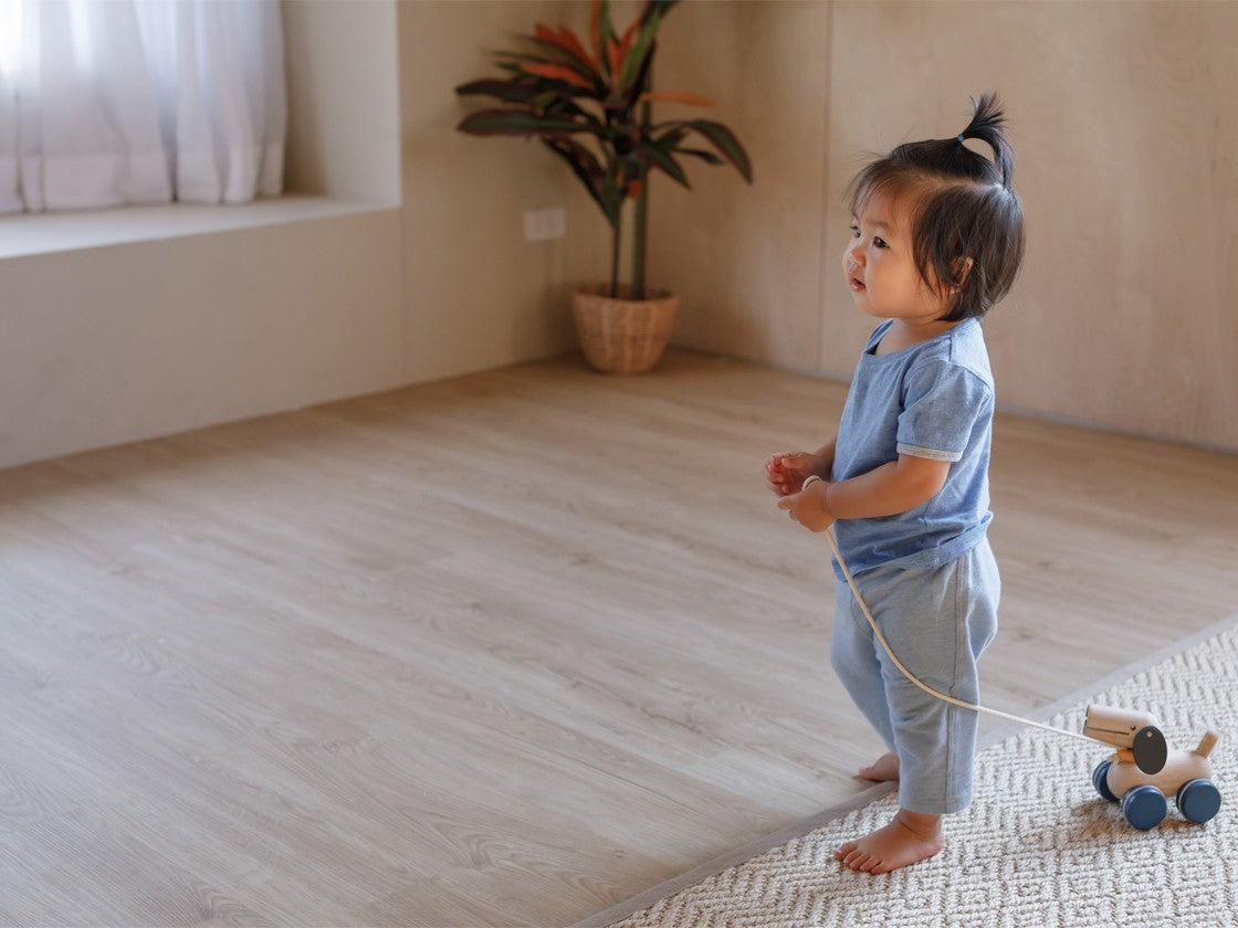 Child walking indoors pulling Push & Pull Puppy