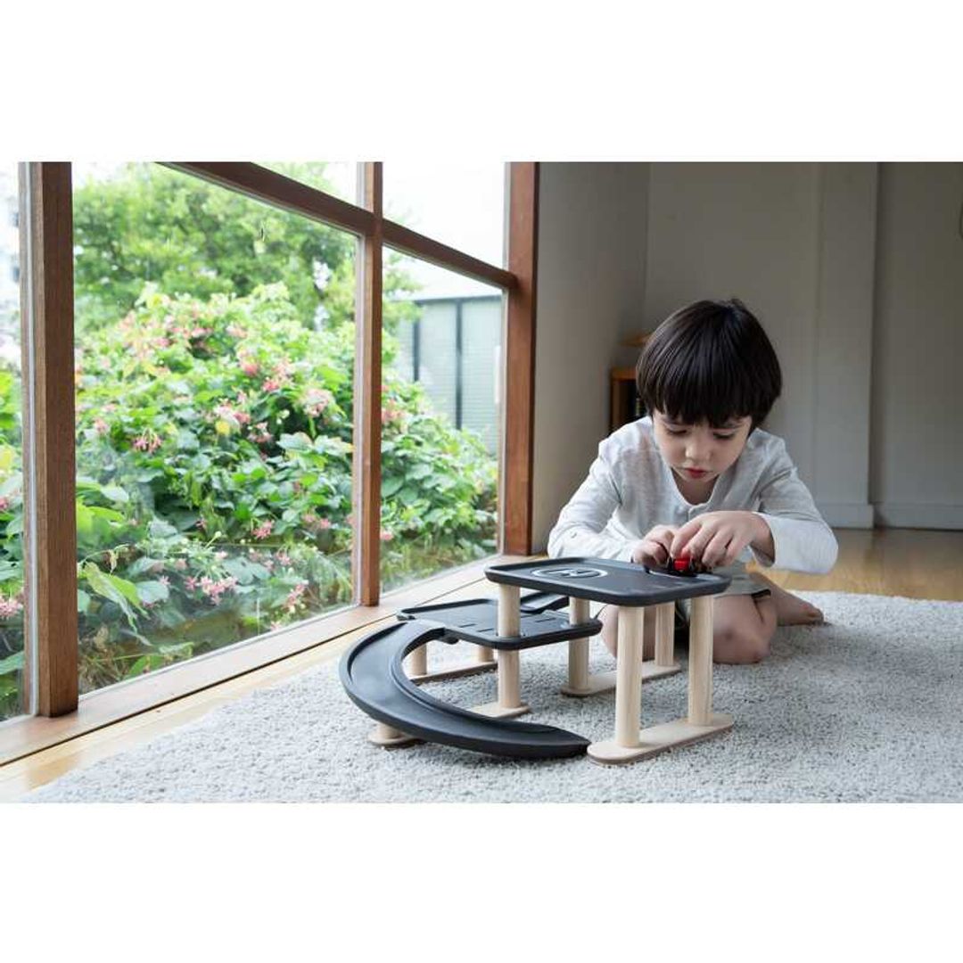 Child Play with Race N Play Parking Garage by Plan Toys