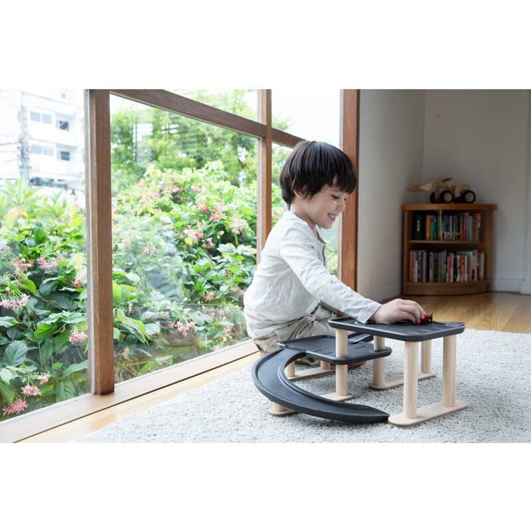 Child Play with Race N Play Parking Garage by Plan Toys