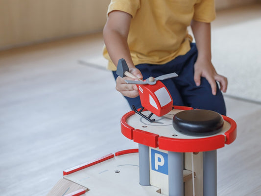 Child playing with helicopter by PlanToys