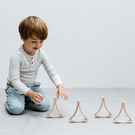 Child playing with able mini building blocks on the floor