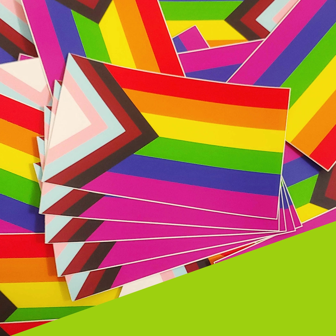 There is a stack of Inclusive Rainbow Pride Stickers
