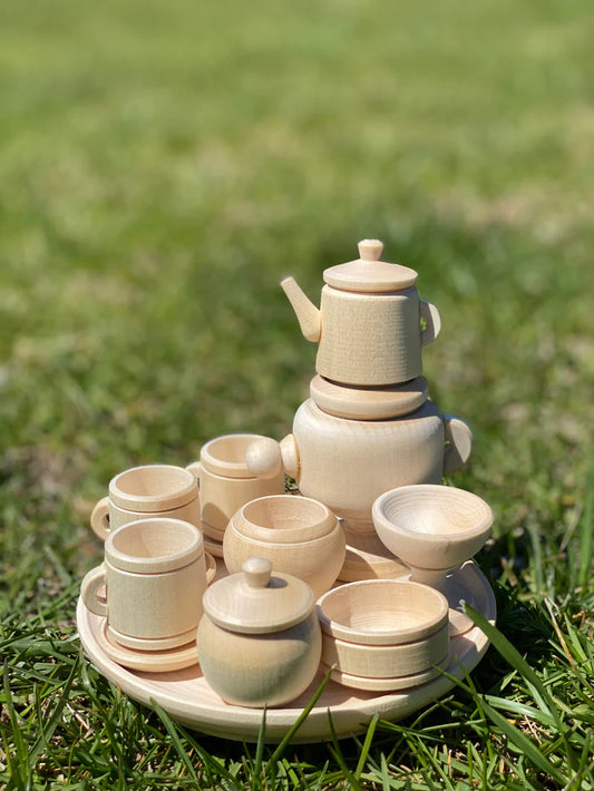 Wooden toy tea set placed on grass