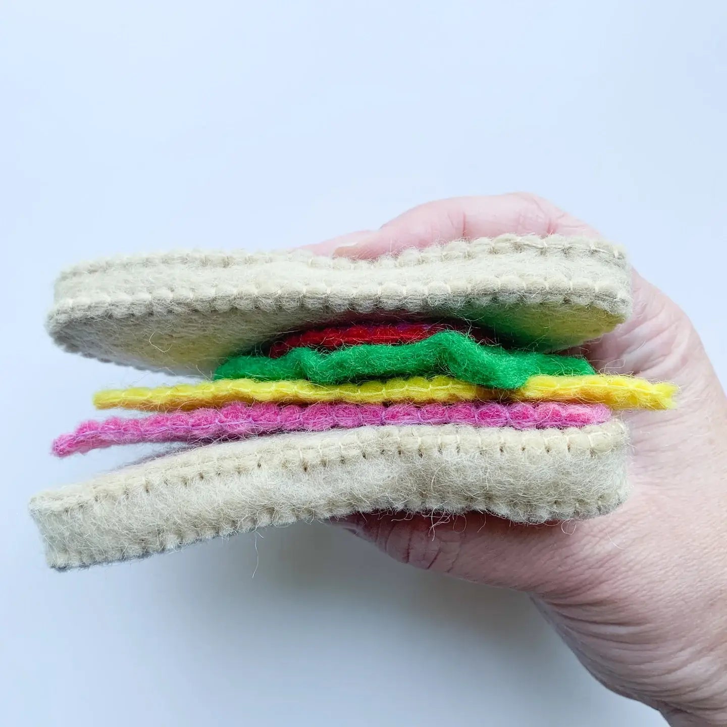 person holding a felt sandwich set