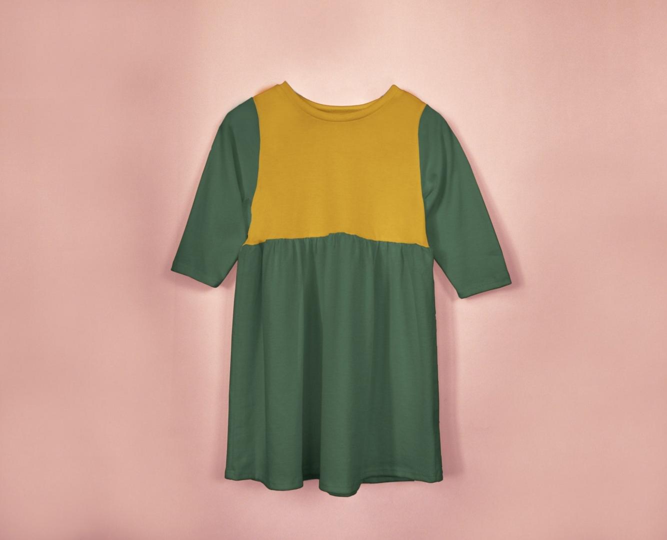 Green and yellow dress on a pink background