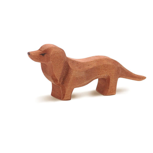 Wooden dachshund figurine on a white background