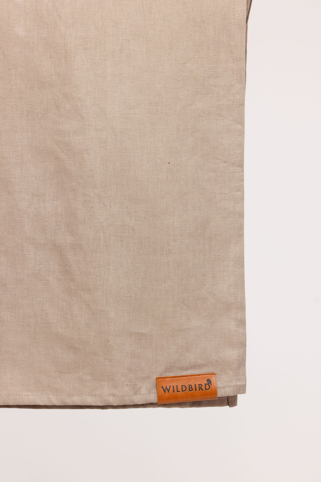 Beige fabric with a 'Wildbird' label on a white background