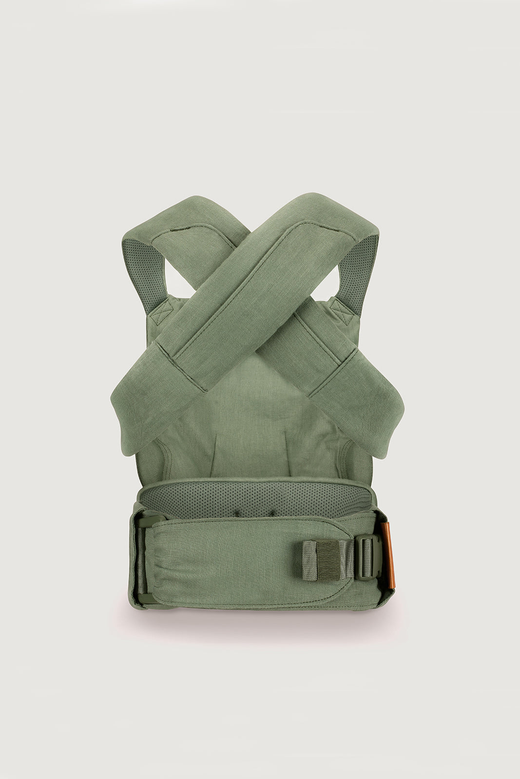 Green baby carrier on a light gray background