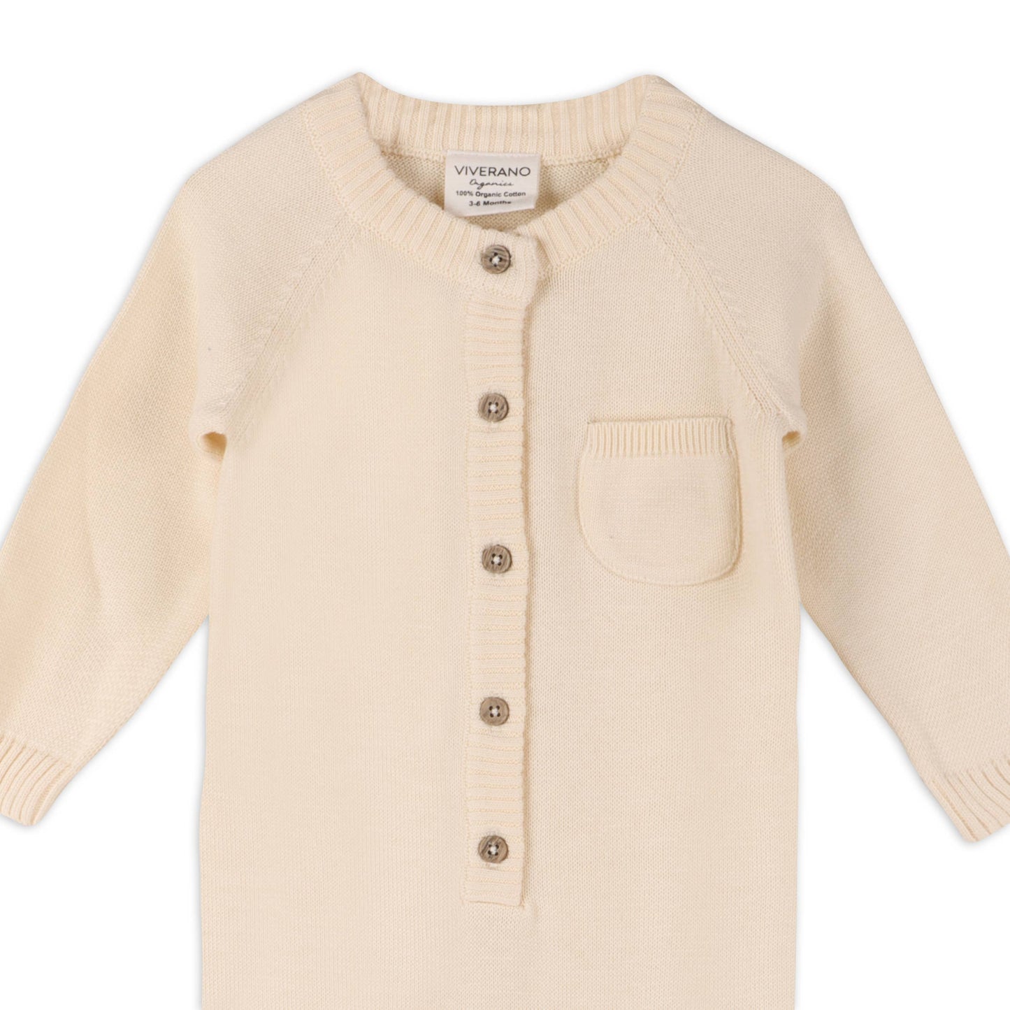 Cream knit romper with button details on a white background