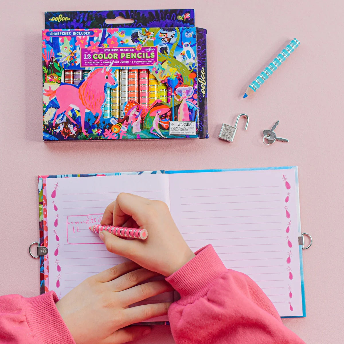 Child wearing a pink sweater writing in a journal with a pink fluorescent pencil