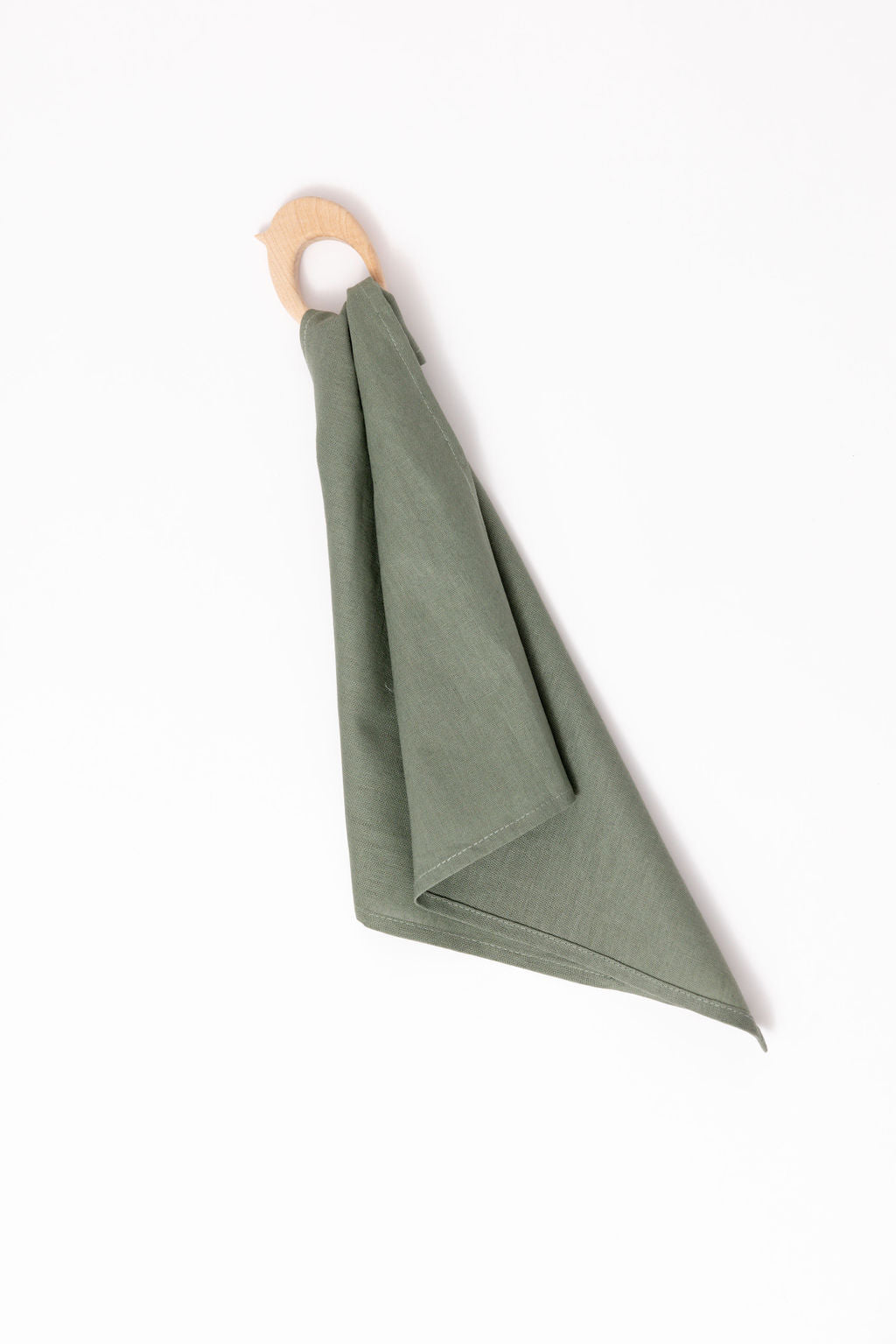 Green folded towel hanging on a wooden ring against a white background