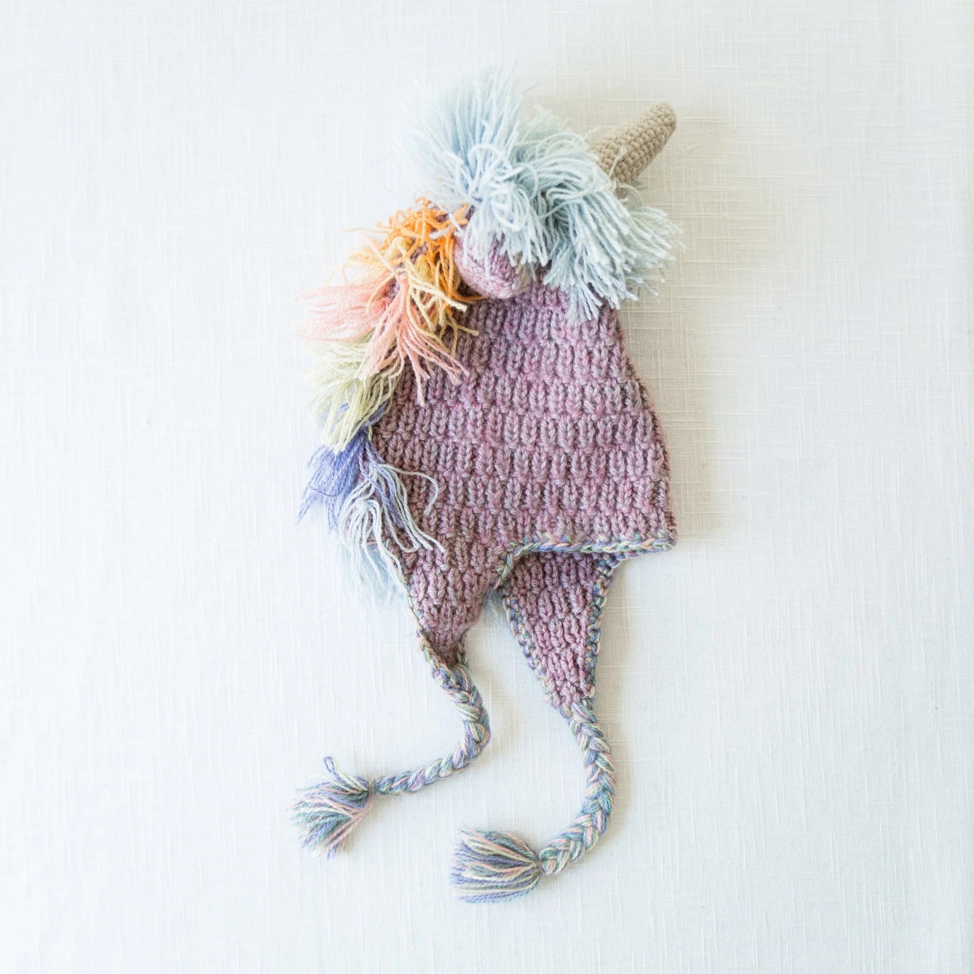 Pastel unicorn wool hat flat lay