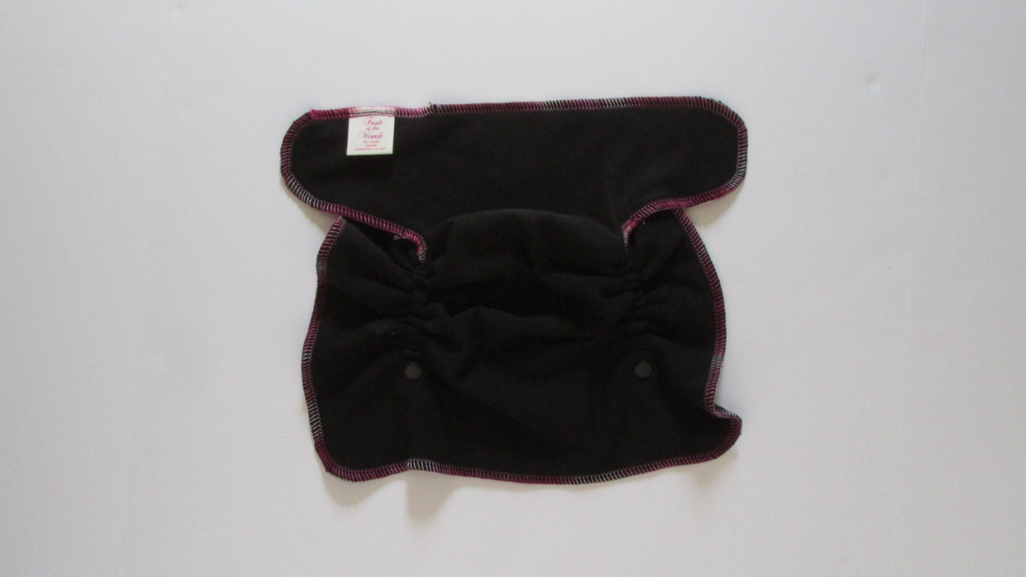 Black cloth diaper with pink trim on a white background