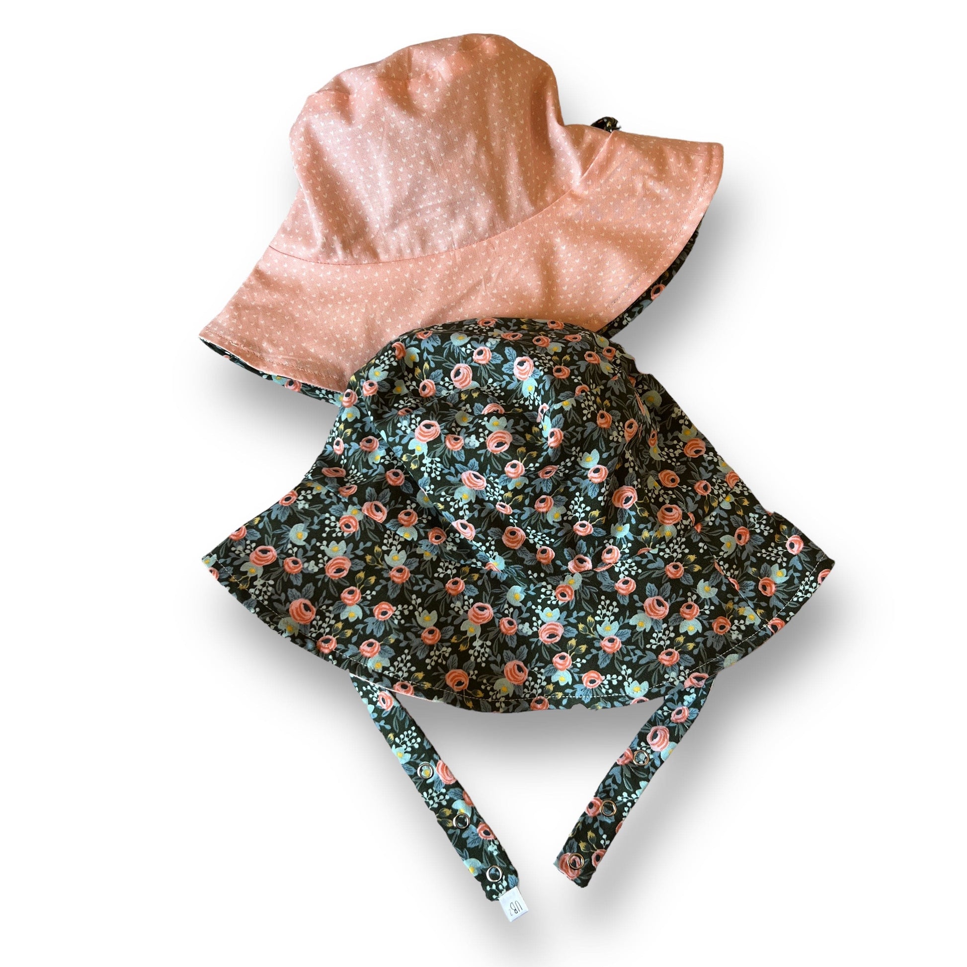 Floral-patterned baby seat cover with pink interior on a white background