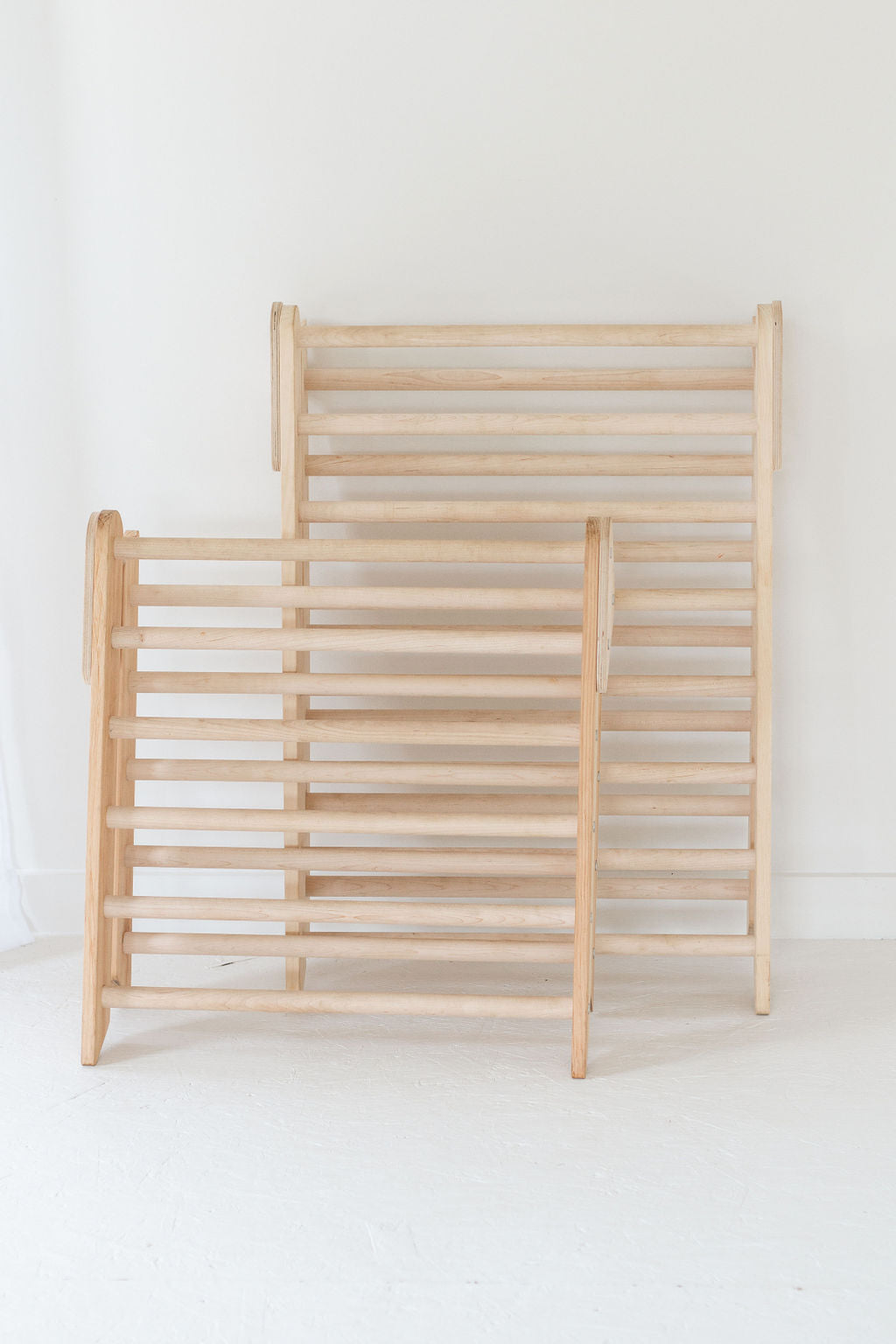 Wooden crib with slatted design on a white background