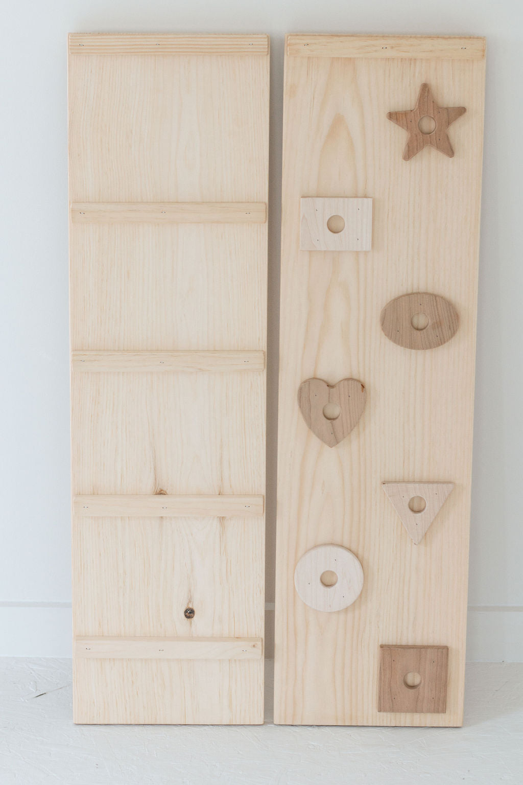 Two wooden panels with cut-out shapes on a white background