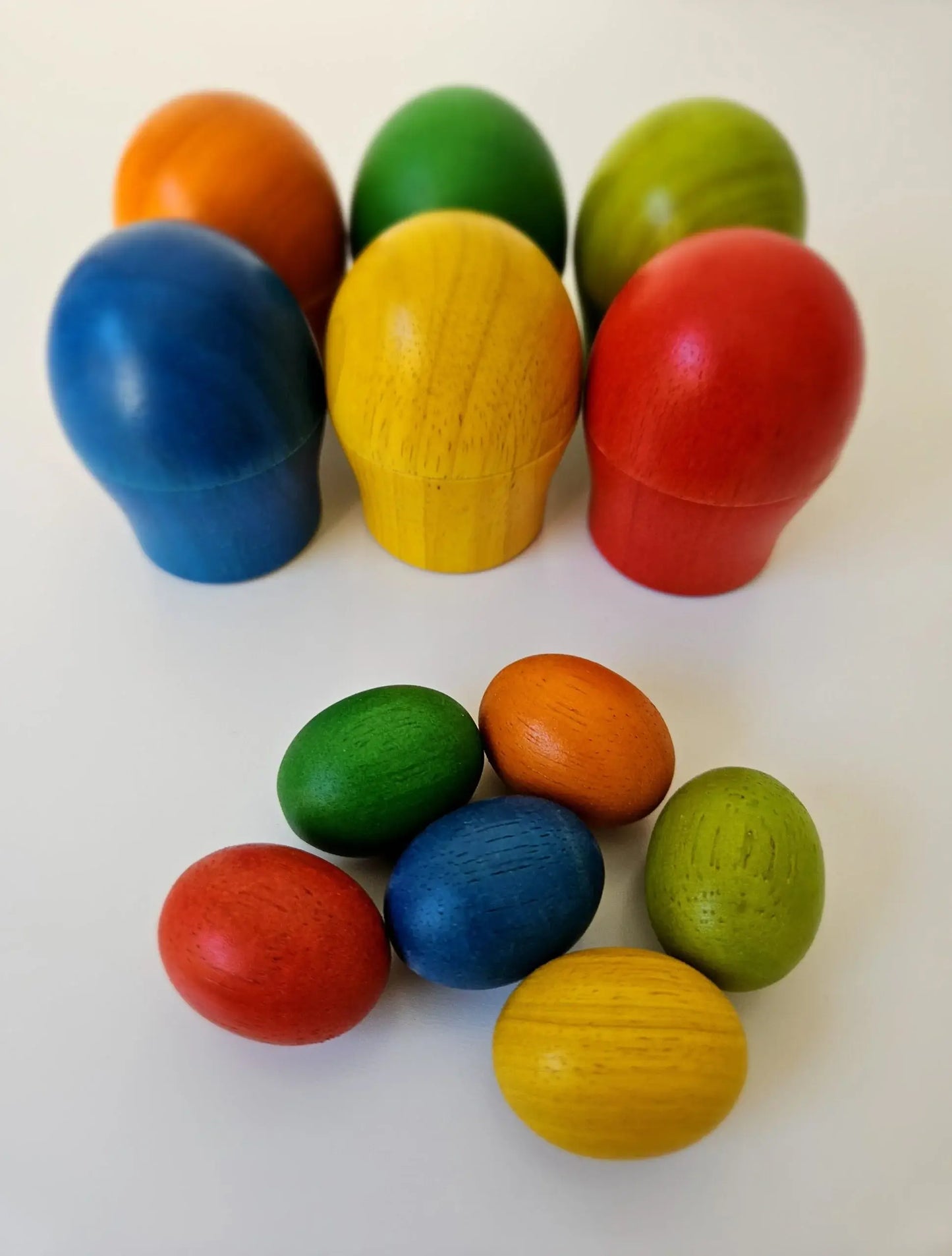 Colorful wooden eggs on a white background