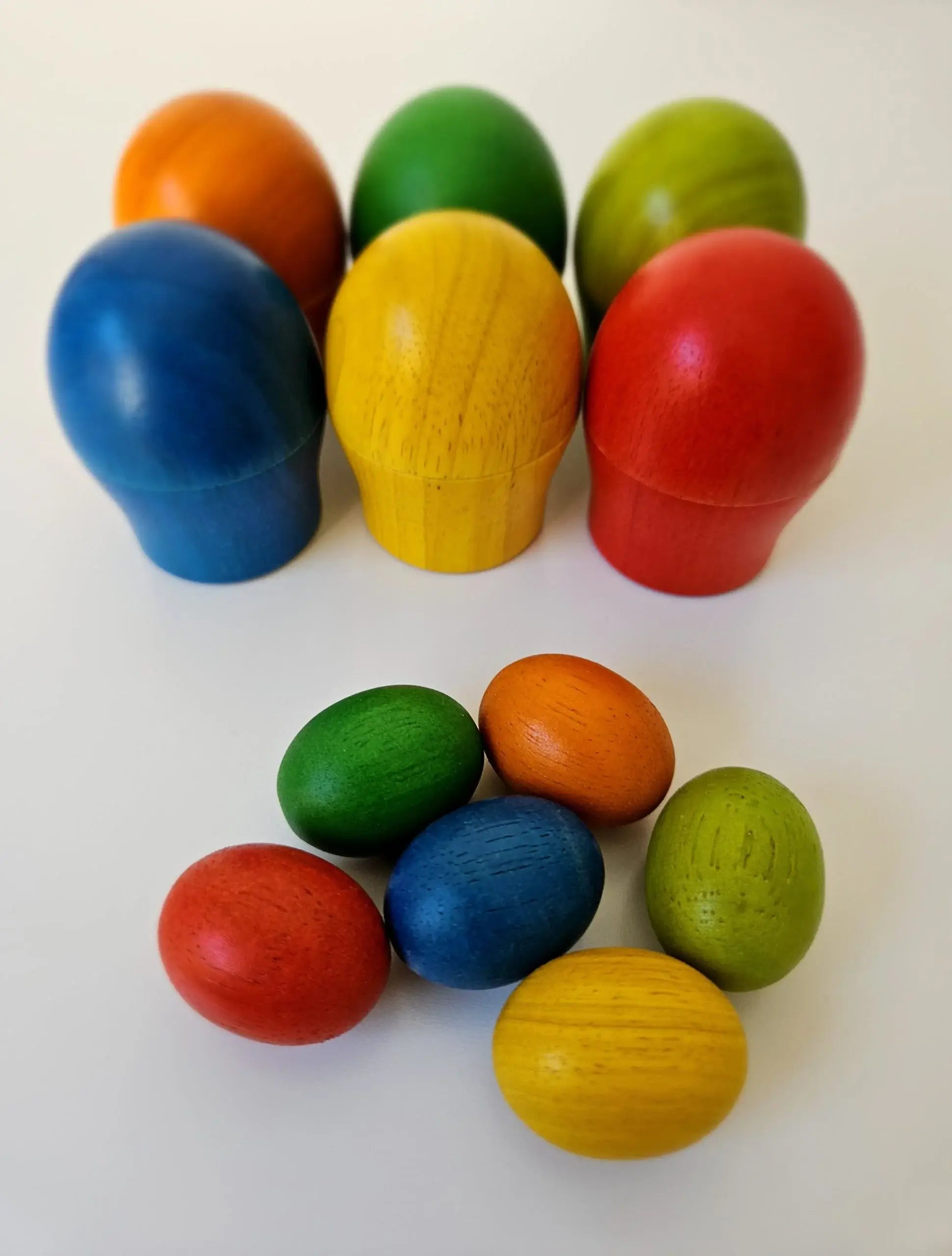 Colorful wooden eggs on a white background