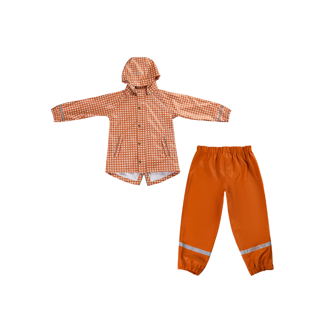 Orange checkered raincoat and matching pants on a white background