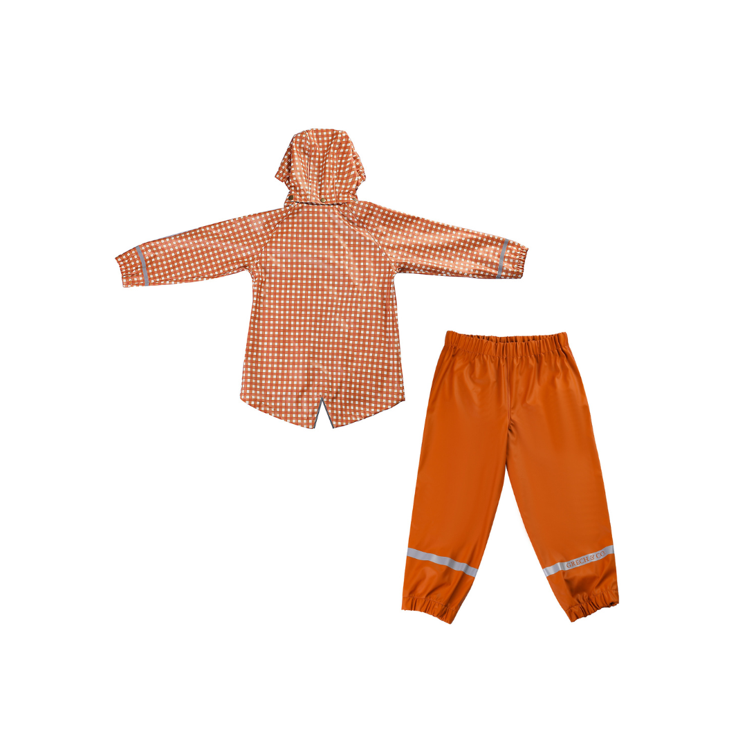 Orange checkered raincoat and pants set on a white background