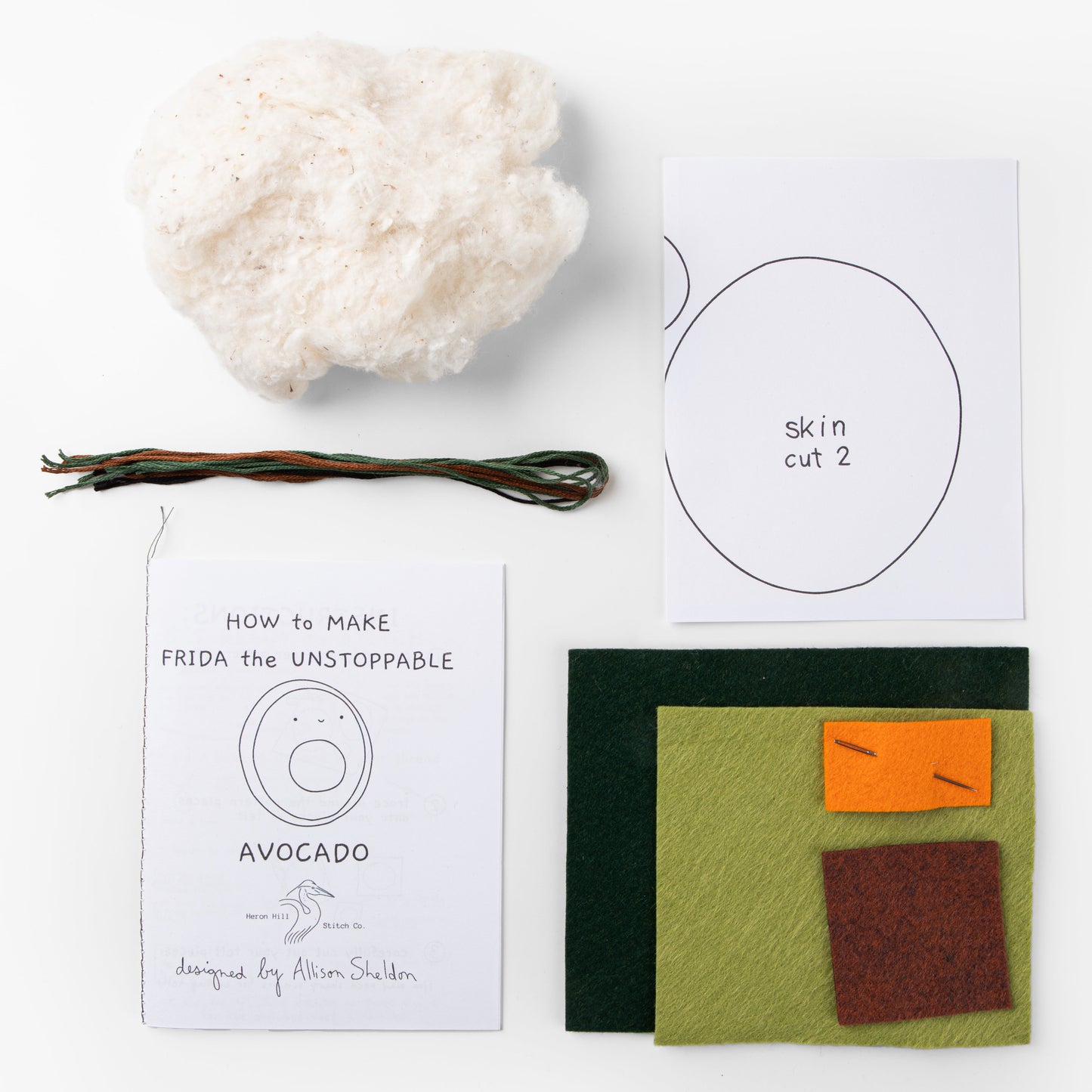 Crafting materials and instructions for creating a felt avocado with a cloud and sticks on a white background.