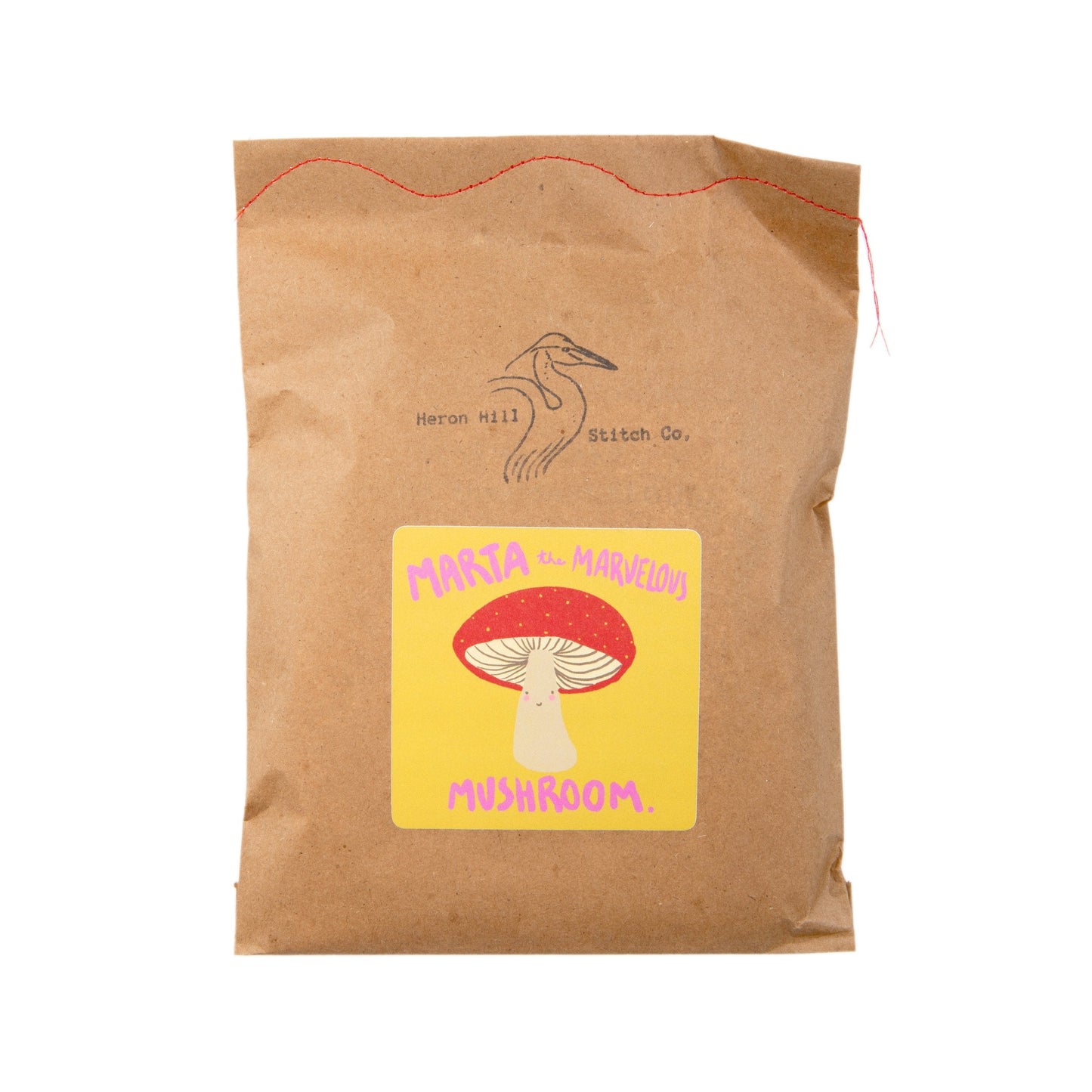 Brown paper bag with a yellow label featuring a mushroom illustration on a white background