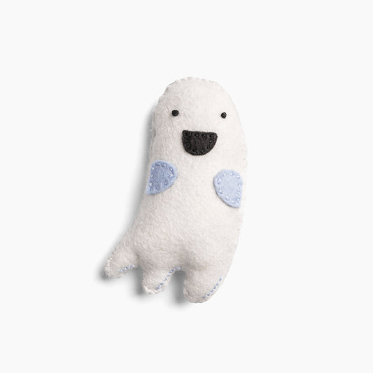 White plush toy with blue accents on a white background