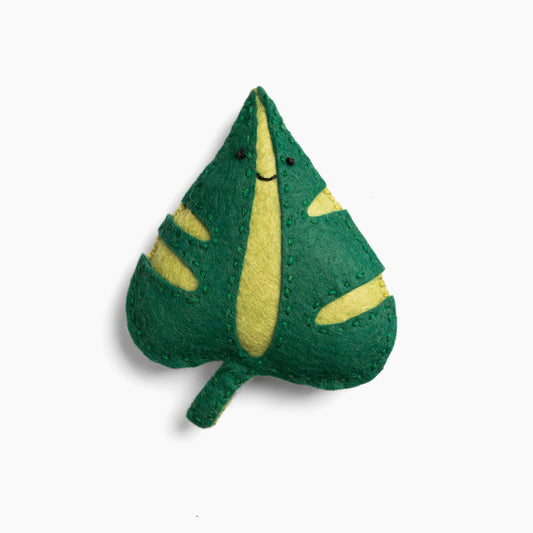 Green and yellow leaf-shaped plush toy on a white background