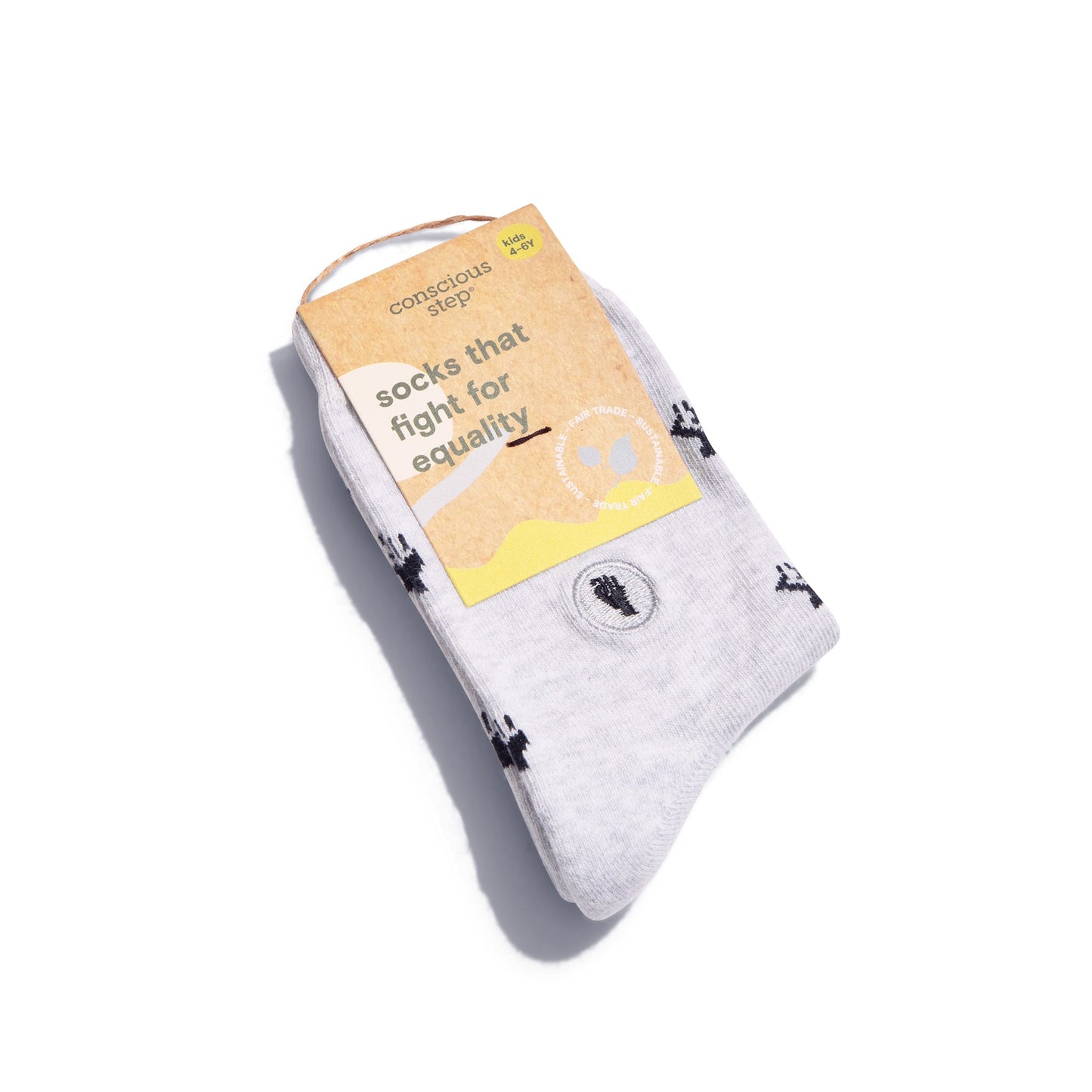 White socks with black paw prints and a yellow label on a white background