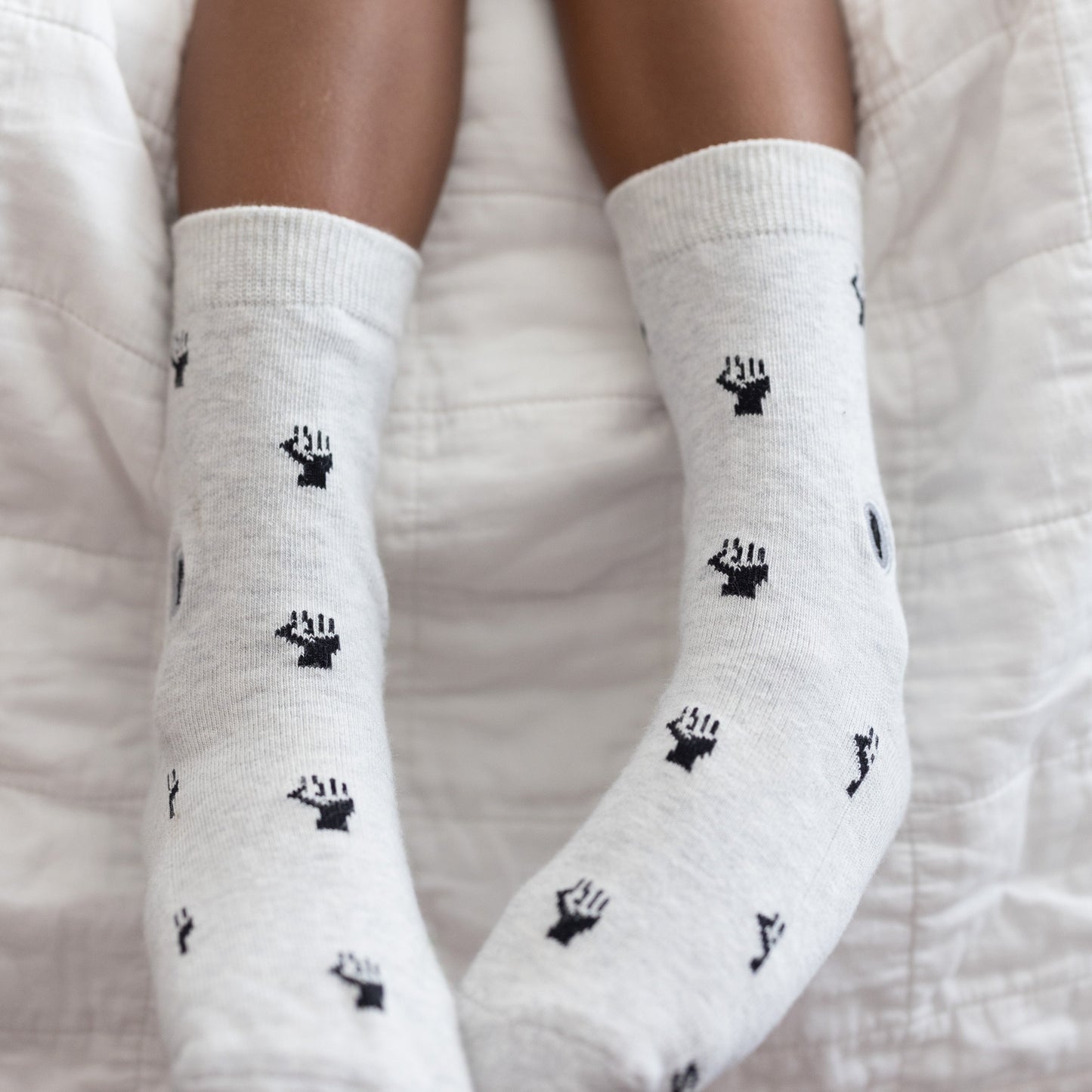 White socks with black handprints on a white background