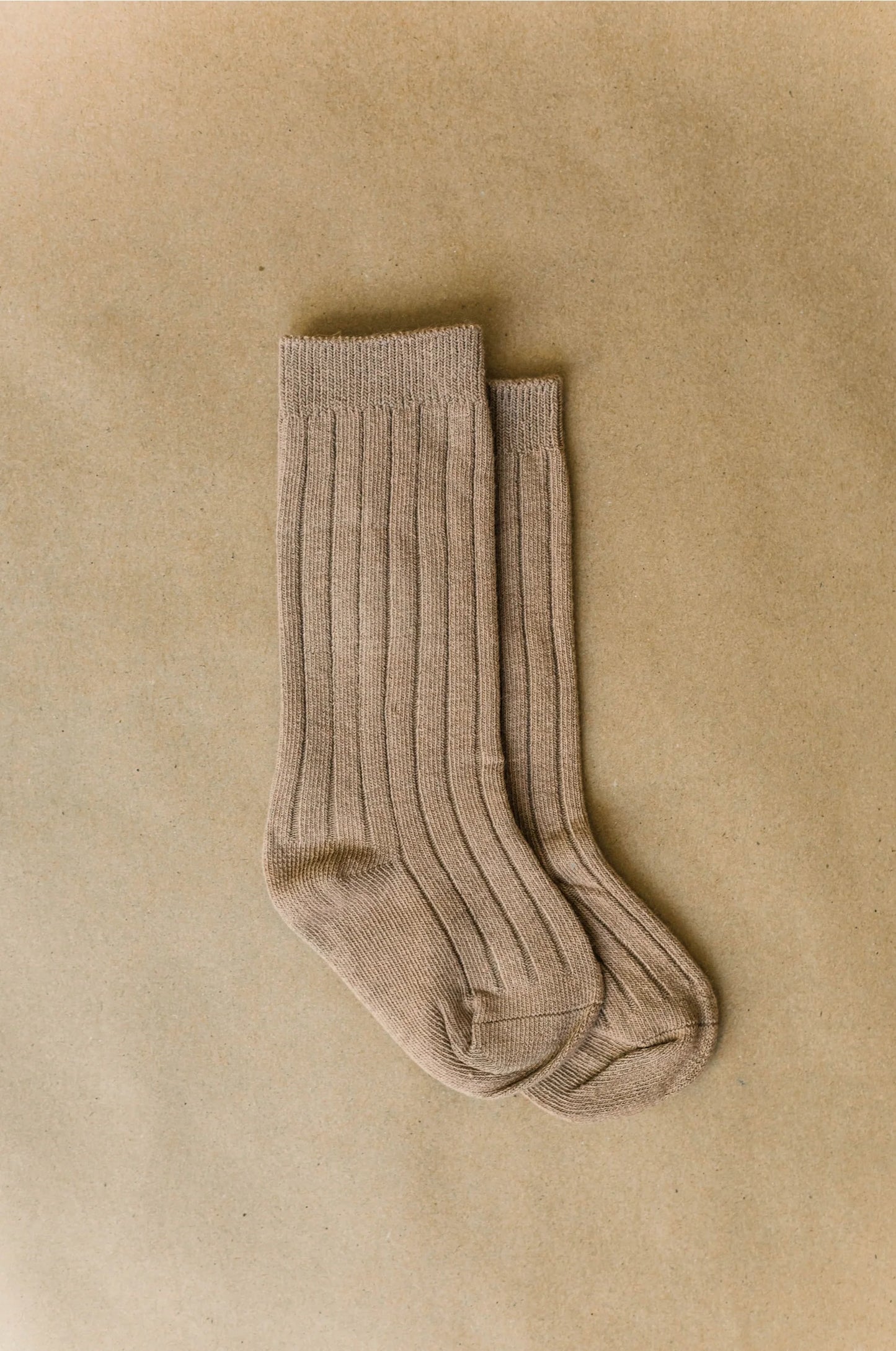 kids Knee high socks light brown ona taupe back ground