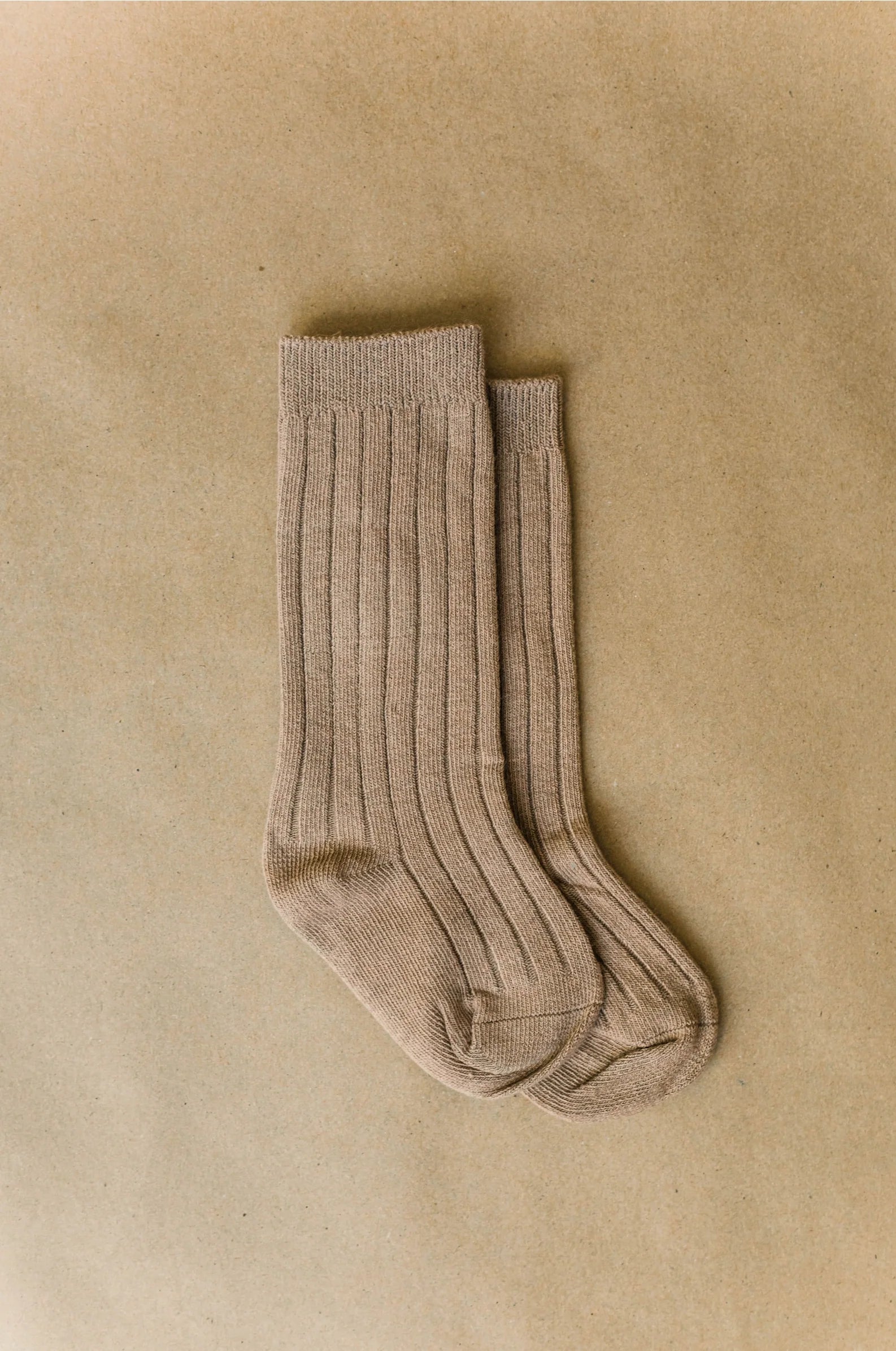kids Knee high socks light brown ona taupe back ground