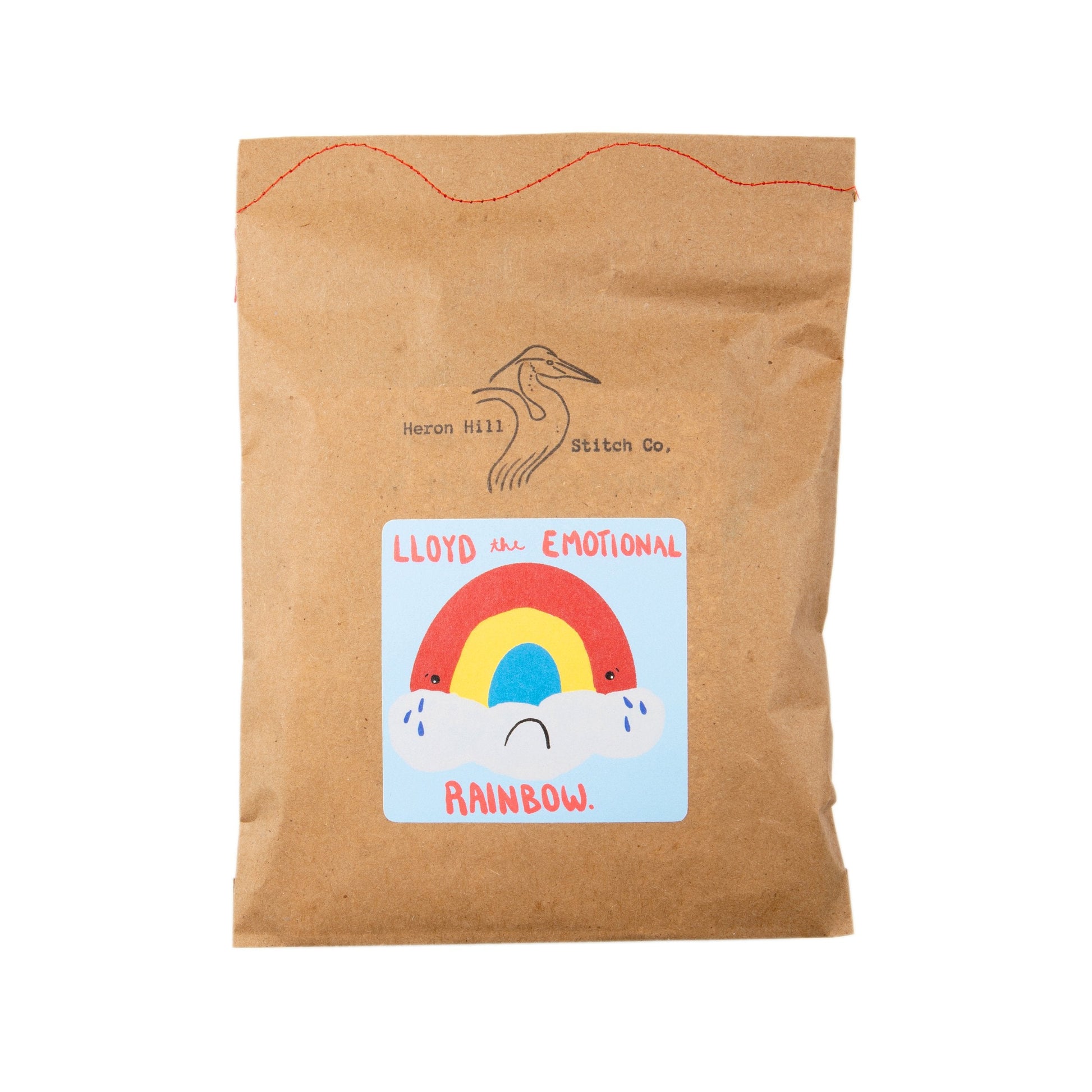 Kraft paper bag with a colorful label featuring a rainbow and text on a white background
