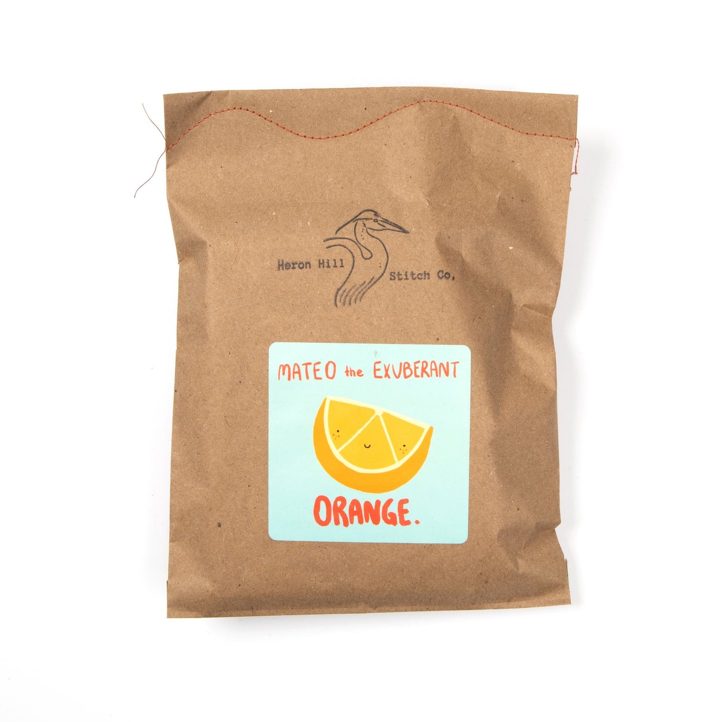 Brown paper bag with a label featuring an orange and text on a white background
