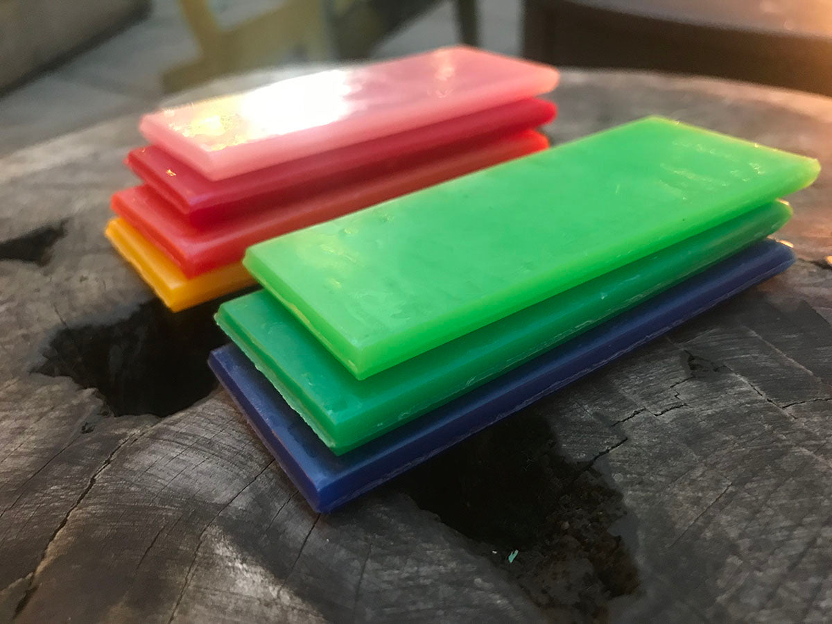 two stacks of modeling wax in assorted colors