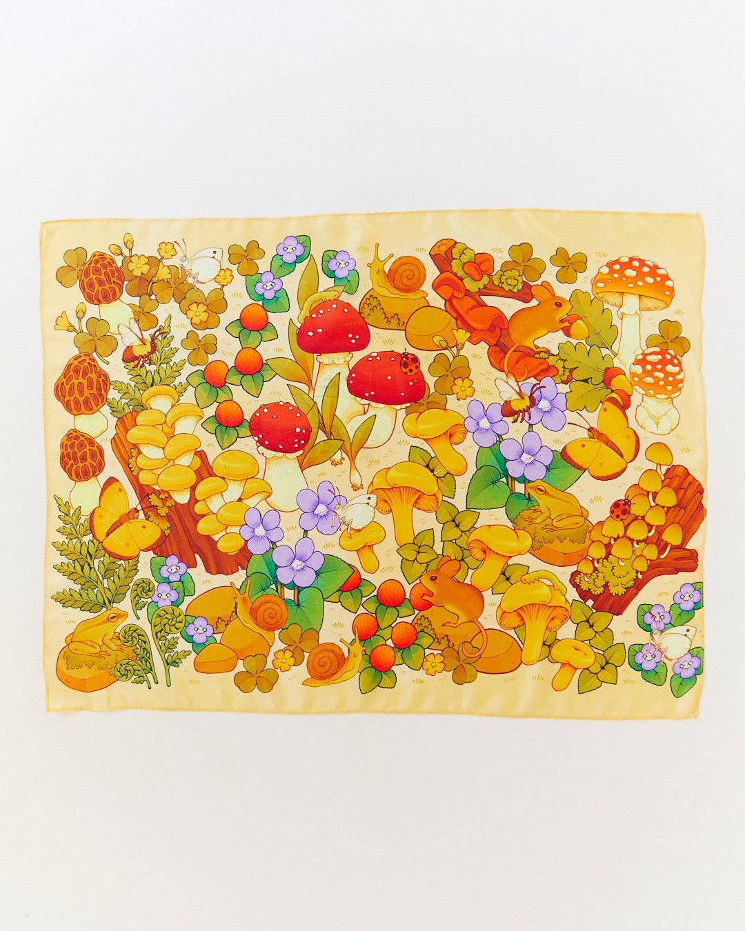 Colorful wooden puzzle with mushrooms, flowers, and butterflies on a light background
