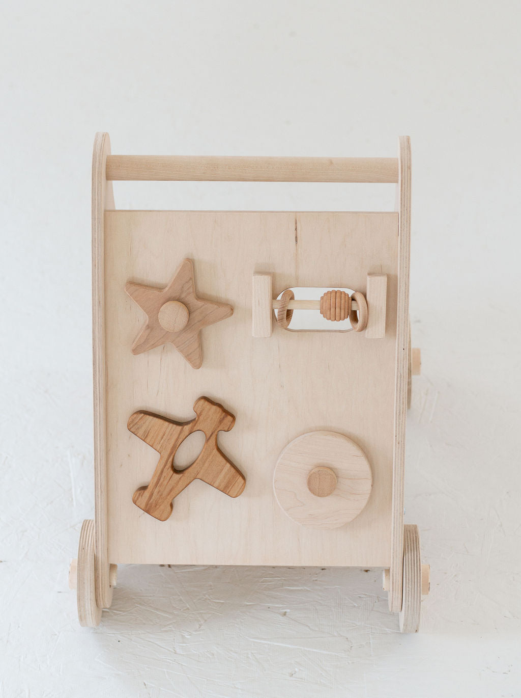 Wooden baby activity center with various shapes on a white background