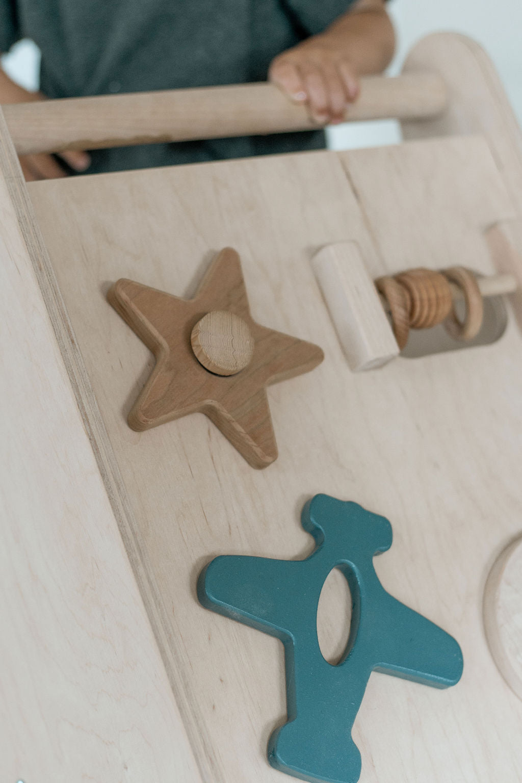 Wooden toy with star and other shapes on a white background