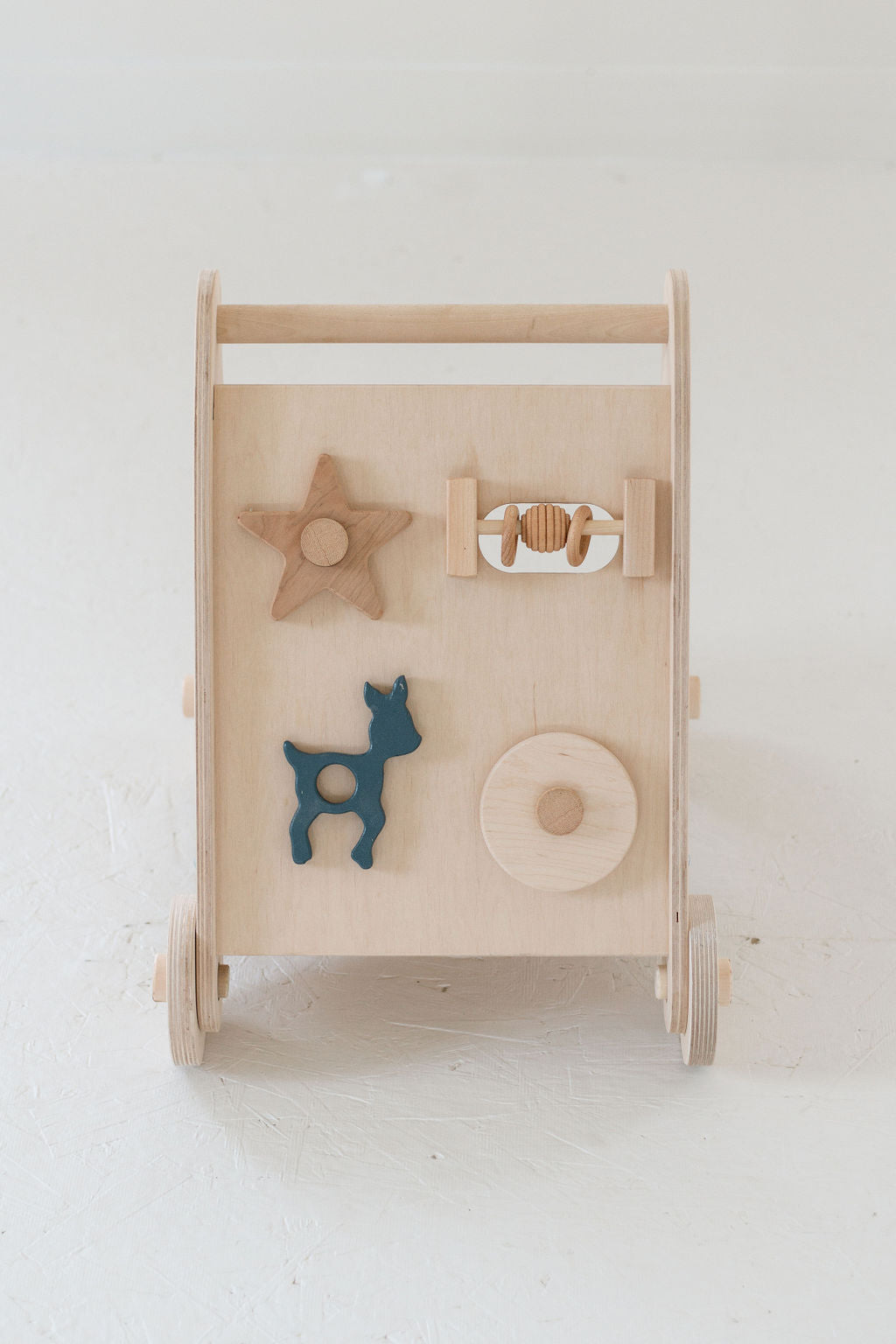 Wooden baby toy with shapes on a white background